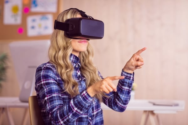 Worker using virtual reality to learn through training and development program